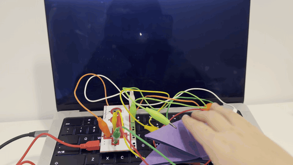 This image shows another hands-on test with Makey Makey and the paper interface.
